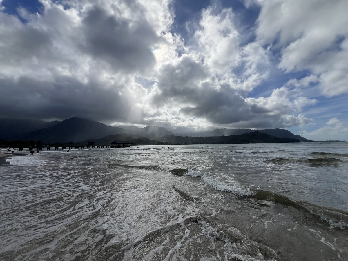 Sun peaking through the clouds over Hanalei Bay, Kauai.